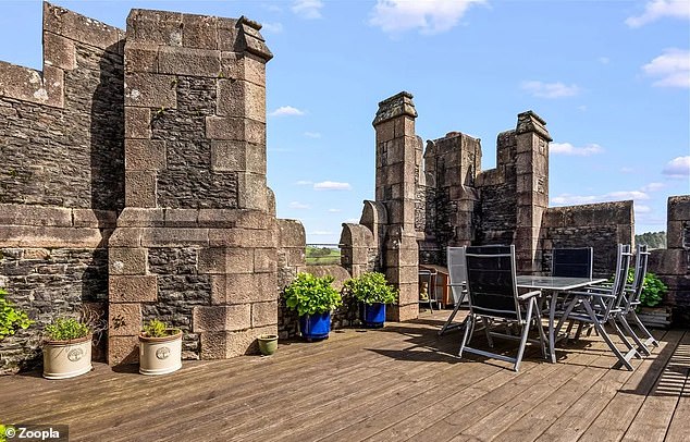 The penthouse has its own roof terrace with decking and is surrounded by turrets