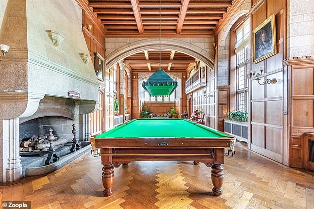 The stately rooms include a dining room, lounge, billiards room and a well-stocked library with four stained glass windows