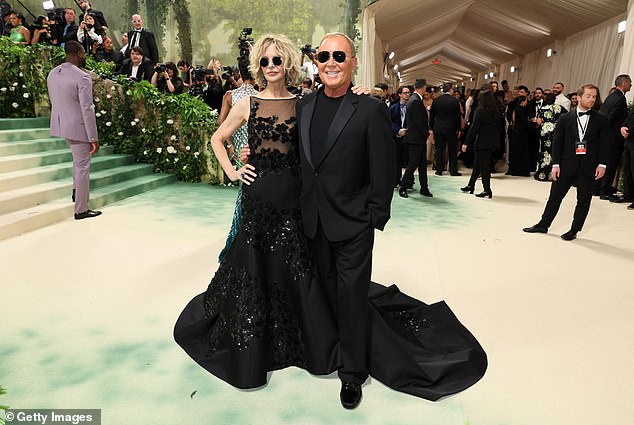 Ryan later donned black Aviator sunglasses to pose next to Michael Kors, who designed the dress she wore for the evening