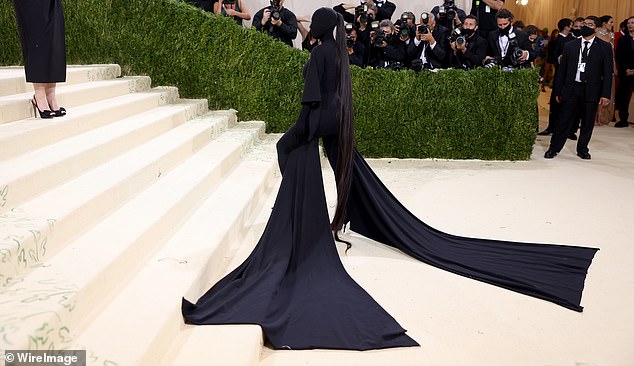 Kim still brought a little bit of him with Kanye to the 2021 Met Gala, completely concealing her body and face in a black figure-hugging suit designed by Balenciaga, Ye's frequent collaborator