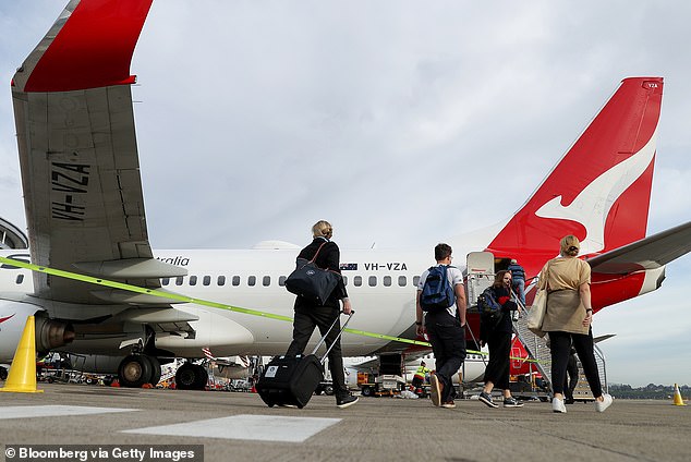 Mr Ross said his fight for reimbursement is about standing up for the 'smaller people' who don't have the resources to take on the airline (Photo: People board a Qantas plane in Sydney)