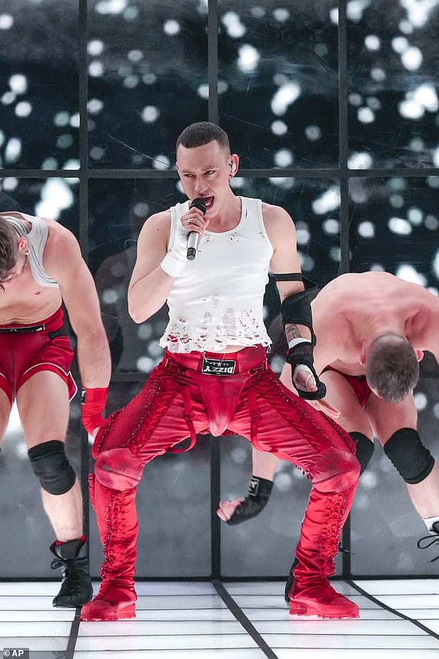 Olly wore a distressed vest and red trousers which were worn with a colour-coordinated jockstrap over the top