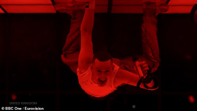 In one go it looked like Olly was hanging from the ceiling as he stuck his tongue out