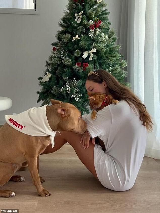 Olivia has been the owner of the four-year-old Bengal cat since moving from home.  Pictured with her dog Malibu