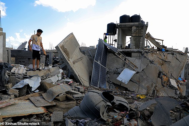 A man stands on the rubble after an Israeli airstrike in the city of Rafah in the southern Gaza Strip, on May 7, 2024