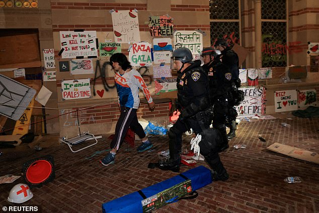 Law enforcement officers walk as they clear the protest camp in support of Palestinians at the University of California, Los Angeles