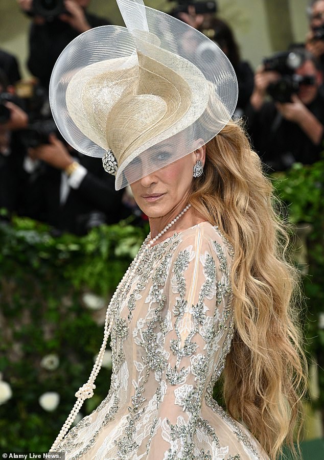 Sarah Jessica Parker wore a bouquet of stripper hair extensions under a fascinator and Andy Cohen on her arm, but she still managed to look like an expensive lampshade.