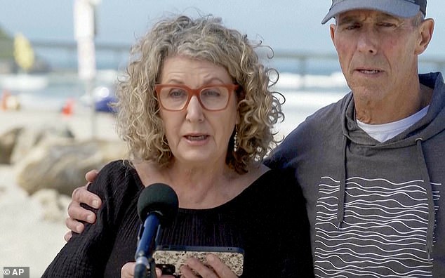 Debra and Martin Robinson are pictured paying a heartfelt tribute to their sons in San Diego on Tuesday