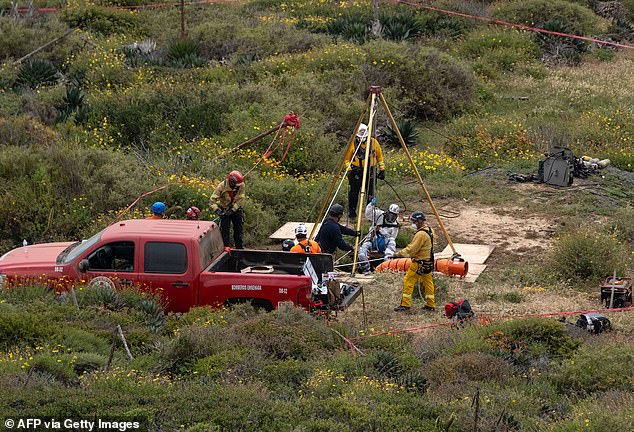 It took rescuers up to 20 hours to remove the men's bodies from the pit (photo)