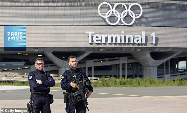 French police officers stand guard outside Terminal 1 at Roissy-Charles de Gaulle Airport ahead of this summer's Olympic Games