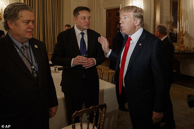 Bannon is seen in the White House State Dining Room with President Donald Trump and technology entrepreneur Elon Musk in February 2017