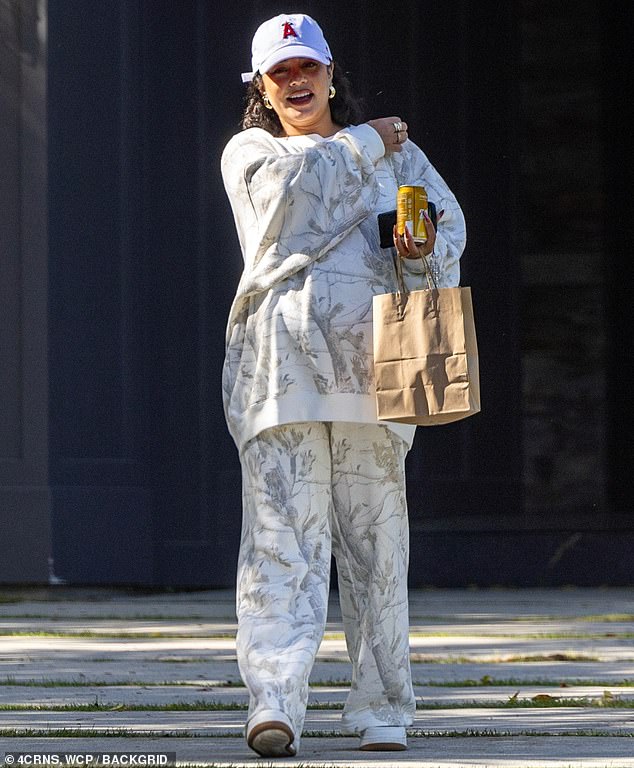 The 35-year-old actress concealed her bump with an oversized white patterned sweatshirt, paired with matching loose-fitting sweatpants