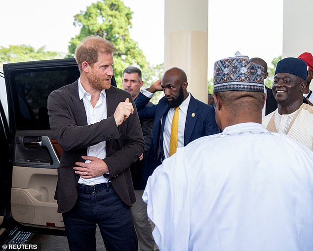 Prince Harry gestures after visiting the Kaduna State Government House in Kaduna, Nigeria