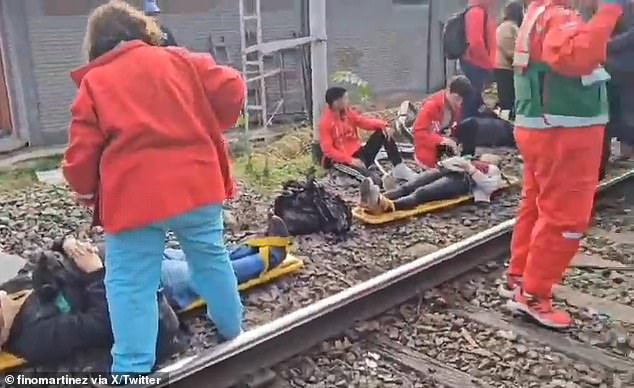 Paramedics tend to injured passengers involved in a train crash in Palermo, Argentina on Friday