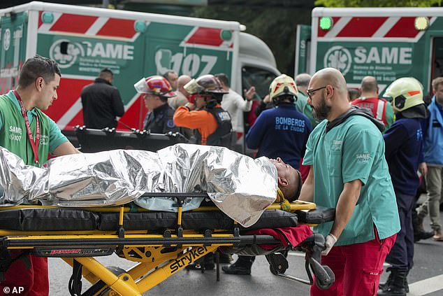 Paramedics transport injured commuters after two trains collided in Buenos Aires, Argentina, on Friday morning