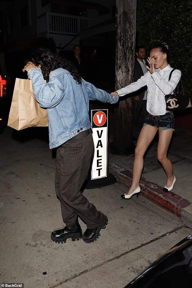 She accessorized her daring ensemble with a black quilted Chanel handbag and white pumps with black tips