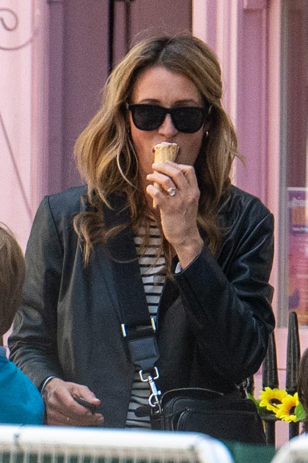 She seemed to be enjoying her ice cream as she cooled down in the warm weather