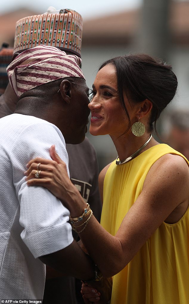 Meghan greeted Lagos Governor Babajide Sanwo-Olu (left) as she arrived at the Governor's House