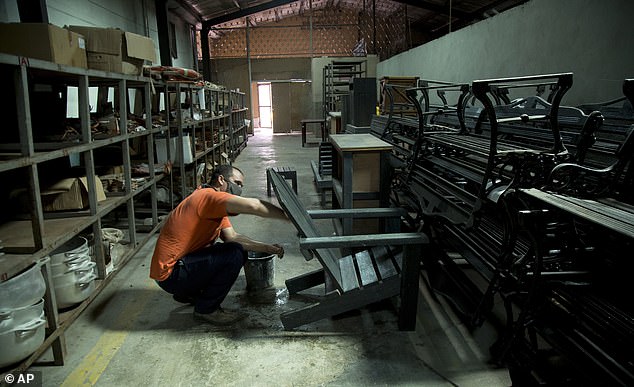 Keytris Leyba, an employee of the Atres Cooperative, cleans furniture made of plastic or ecological wood in Matanzas