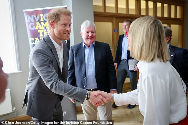 Prince Harry pictured meeting Louise Minchin at the Invictus Games event at Armory House on May 7