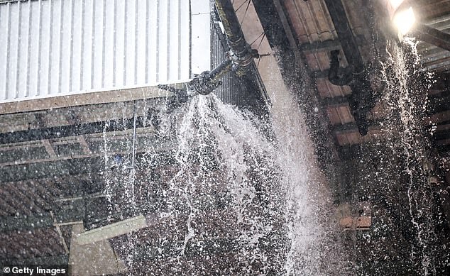 Spectators were shocked as rainwater poured through Old Trafford's leaking roof at almost full time