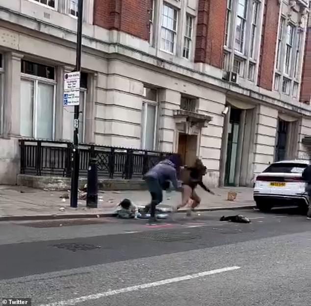 Grim images have emerged of the two thugs brazenly punching and kicking the pair in Eversholt Street, north London, before apparently making off with some of their belongings.  Each man attacks one victim during the robbery as shocked bystanders watch and cars drive down the busy street in the capital