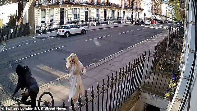 The balaclava-clad criminal wasted no time in grabbing his startled victim's phone before speeding off down a fashionable street near the center of the capital.