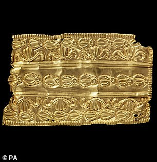 An elongated gold repousse ornament