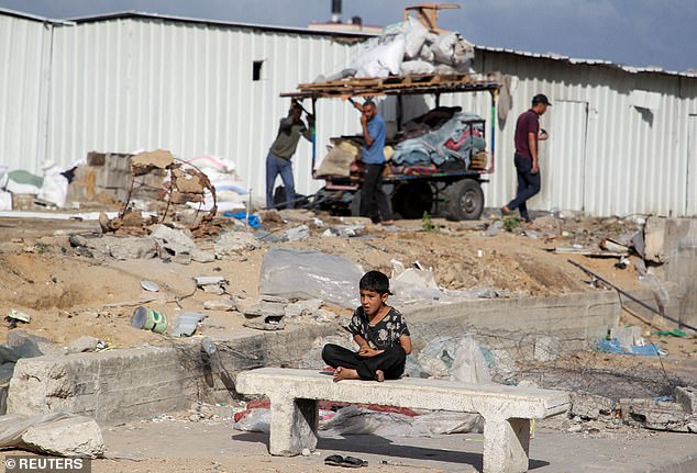 A boy watches as Palestinians prepare to flee Rafah after Israeli forces launched a ground and air operation in the eastern part of the southern Gaza city.  President Joe Biden halted a shipment of bombs to Israel over concerns about Rafah operations