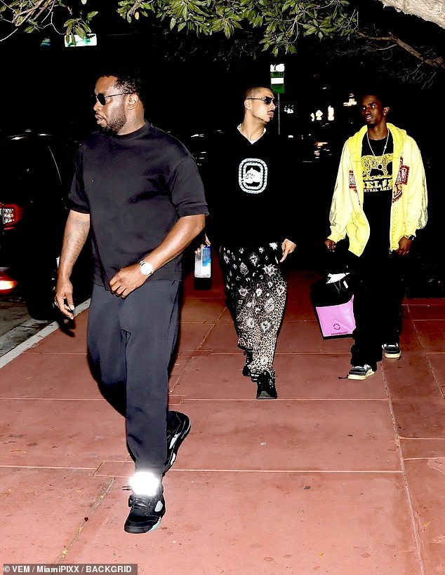 The hip-hop mogul wore an all-black ensemble as he was pictured outside the South Florida eatery with sons Quincy, 32, and Christian, 25