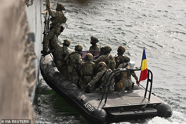 A Romanian Special Forces officer boards the Romanian frigate 'King Ferdinand' during the NATO-led Sea Shield 2024 exercise in the Black Sea, outside Constanta, Romania on April 16, 2024