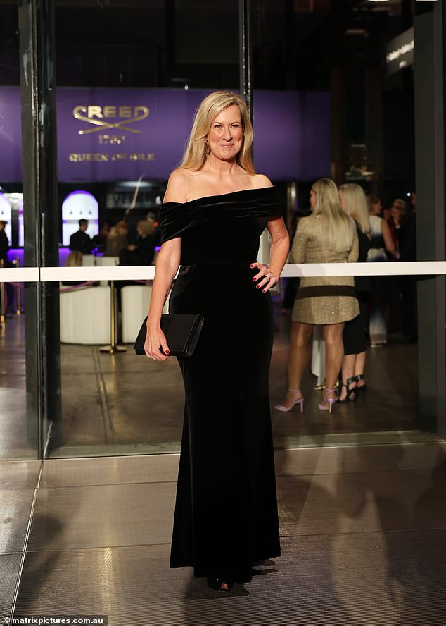 Melissa Doyle (pictured) kept it classy in a tight black velvet dress that fell off her shoulders and reached the floor