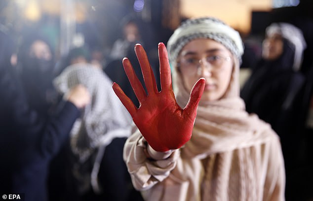 A protester shows a hand covered in fake blood as pro-Palestinian supporters gather for an anti-Israel rally in 2023 to show solidarity with the Gaza people in Palestine Square in Tehran, Iran