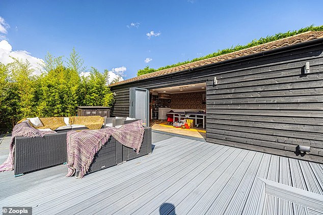 There is an outbuilding with a terrace that can be used for entertaining family and friends