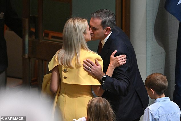 Treasurer Jim Chalmers kisses wife Laura after presenting the 2024-2025 budget