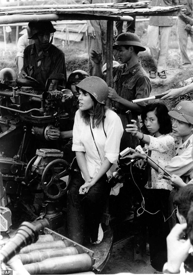 Actress Jane Fonda, seen near a North Vietnamese anti-aircraft gunnery surrounded by soldiers and reporters, sings an anti-war song near Hanoi during the Vietnam War in this July 1972 file photo