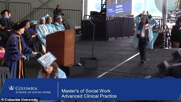 A graduate social worker walked onto the stage with her hands zipped above her head as cheers rang out from the audience