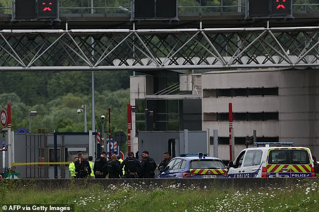 Police officers gather at the scene of the deadly attack in Normandy this morning