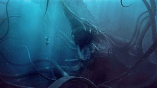 A woman floats in some water as a giant tentacle monster approaches in The Rings of Power season 2