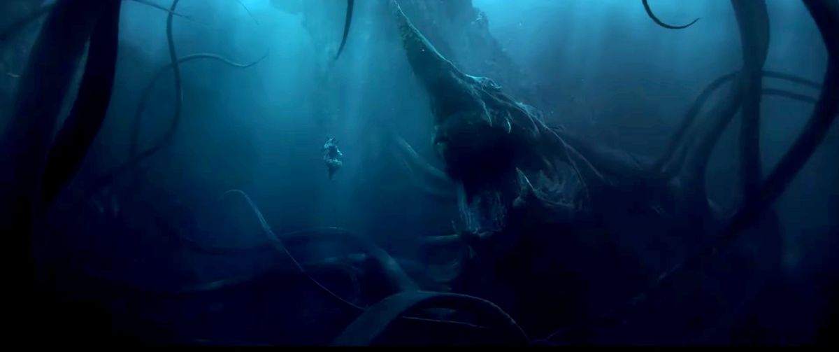 A huge sea monster with tentacles, a crop of snapping teeth and a bow-like spike on its head floats with its mouth open in front of a small, floating humanoid figure in the season 2 trailer of The Lord of the Rings: The Rings of Stroom