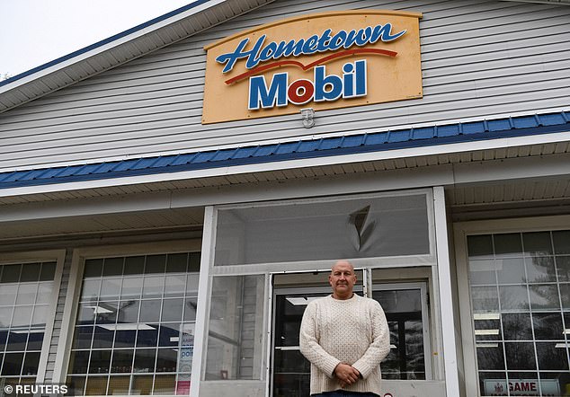 Hometown Gas & Grill owner Fred Cotreau poses for a photo in his store after the win last January