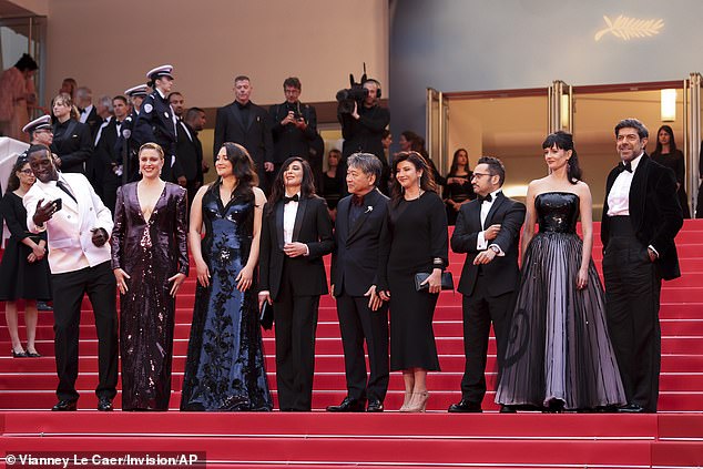 Judge Greta Gerwig, second class left, poses with judges Omar Sy, from left, Lily Gladstone, Nadine Labaki, Kore-eda Hirokazu, Ebru Ceylan, JA Bayona, Eva Green and Pierfrancesco Favino