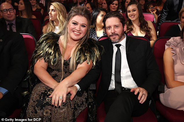 The singer, 42, is said to have been 'oblivious' to the growing speculation as she was preoccupied with her ongoing divorce from estranged husband Brandon Blackstock, 47.