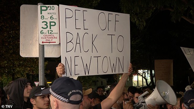 The protesters (pictured) are kept apart by a heavy police presence due to the emotional issue that has increased tensions in the area and across the city