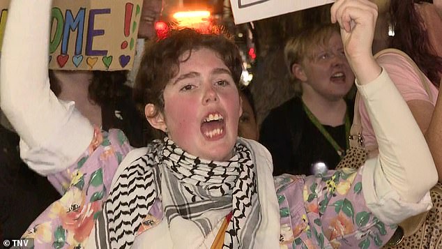 A woman opposed to the book ban is pictured at a protest in Sydney's west on Wednesday evening