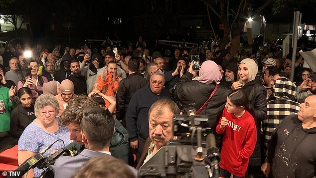 Protesters are pictured at a meeting of rival factions in Sydney's west on Wednesday evening