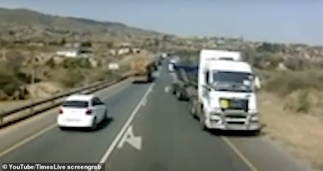 Other vehicles are forced onto the emergency lane as the truck drives down the road