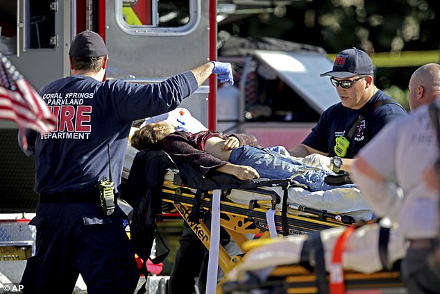 Medical personnel tend to a victim after a shooting at Marjory Stoneman Douglas High School