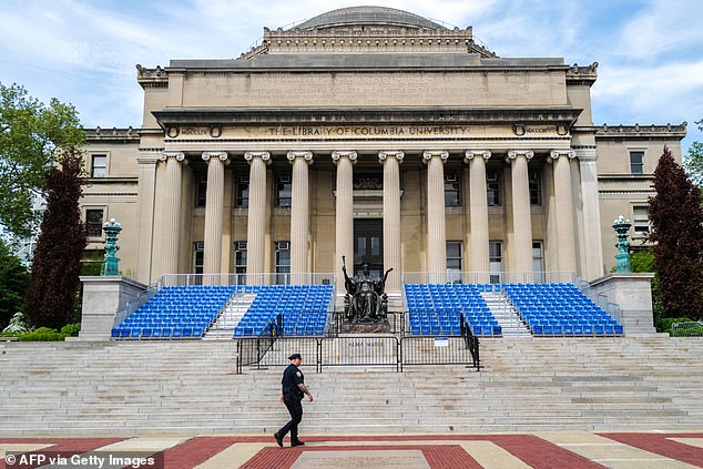 Pictured: A New York police officer patrols Columbia University, the prestigious college at the heart of the US campus protests against the war in Gaza