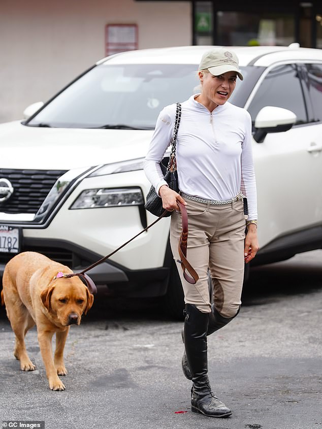 She wore a sporty white long-sleeved shirt with a zippered collar, which had stains on her right upper arm